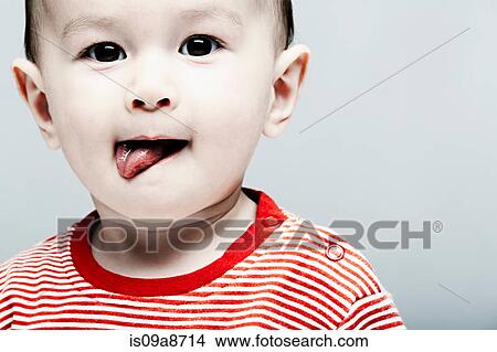 Portrait of baby boy wearing striped top looking at camera View Large Photo Image Picture - Portrait of baby boy wearing striped top looking at camera. Fotosearch