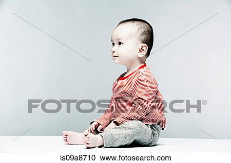 Portrait of baby boy wearing striped top looking away View Large Photo Image Stock Image - Portrait of baby boy wearing striped top looking away. Fotosearch