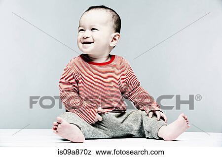Portrait of baby boy wearing striped top looking away View Large Photo Image Stock Photo - Portrait of baby boy wearing striped top looking away. Fotosearch