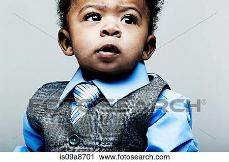Stock Image - Portrait of baby boy wearing waistcoat, shirt and tie. Fotosearch