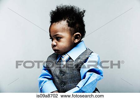 Stock Image - Portrait of baby boy wearing waistcoat, shirt and tie. Fotosearch
