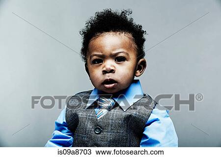 Stock Image - Portrait of baby boy wearing waistcoat, shirt and tie. Fotosearch