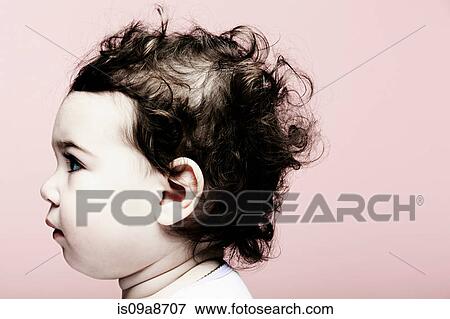 Stock Photo - Portrait of baby girl against pink background. Fotosearch