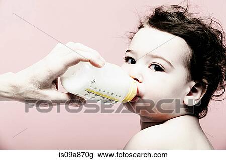 Portrait of baby girl drinking milk from bottle View Large Photo Image Stock Image - Portrait of baby girl drinking milk from bottle. Fotosearch