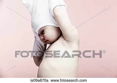Portrait of baby girl taking off top View Large Photo Image Stock Image - Portrait of baby girl taking off top. Fotosearch