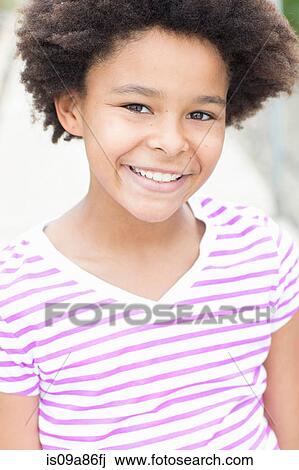 Stock Image - Portrait of girl wearing striped t shirt. Fotosearch