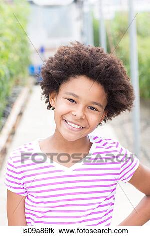 Stock Image - Portrait of girl wearing striped t shirt. Fotosearch