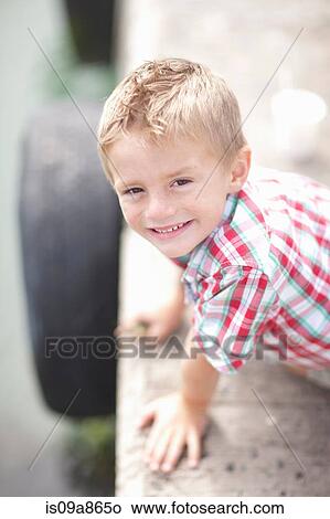 Portrait of young boy leaning on pier wall View Large Photo Image Picture - Portrait of young boy leaning on pier wall. Fotosearch
