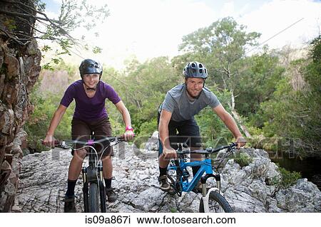 Portrait of young couple with mountain bikes on rock View Large Photo Image Stock Image - Portrait of young couple with mountain bikes on rock. Fotosearch