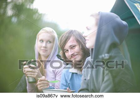 Stock Photo - Portrait of young group of people in front of tent. Fotosearch