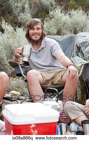 Stock Photography - Portrait of young male hiker taking a break. Fotosearch