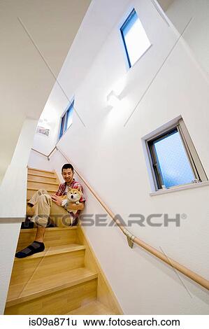 Portrait of young man and dog on wooden staircase View Large Photo Image Stock Photograph - Portrait of young man and dog on wooden staircase. Fotosearch