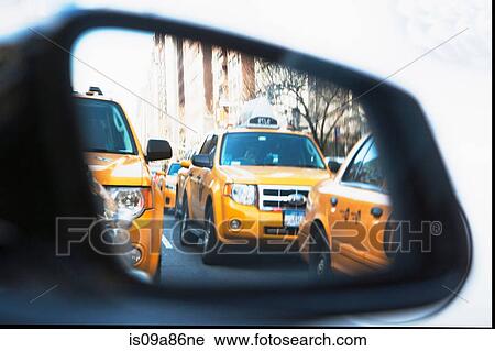Queue of yellow cabs viewed through wing mirror, New York City, USA View Large Photo Image Stock Image - Queue of yellow cabs viewed through wing mirror, New York City, USA. Fotosearch