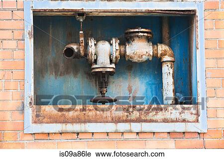 Rusting pipes inside red brick wall View Large Photo Image Stock Image - Rusting pipes inside red brick wall. Fotosearch