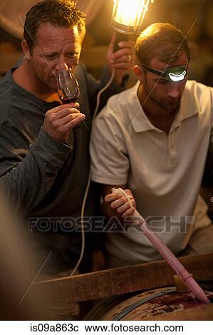 Stock Image - Sampling wine in barrels. Fotosearch