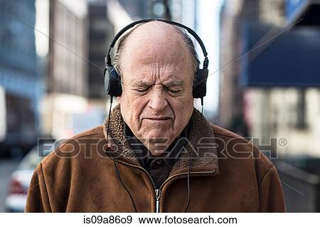 Senior man with eyes closed wearing headphones View Large Photo Image Stock Photo - Senior man with eyes closed wearing headphones. Fotosearch
