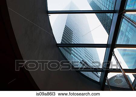 Stock Image - Skyscrapers through curved window. Fotosearch