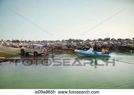 Small group of men landing dinghy in harbor View Large Photo Image Stock Image - Small group of men landing dinghy in harbor. Fotosearch
