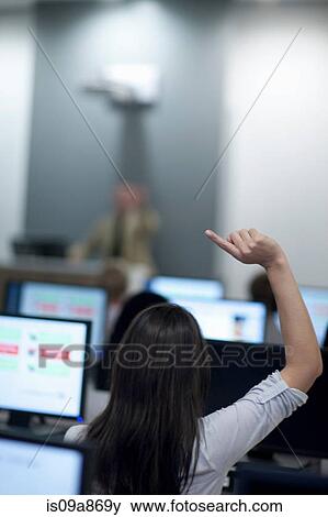 Stock Photo - Student with arm raised in lecture. Fotosearch