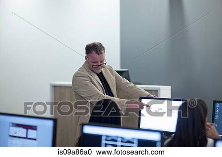 Stock Image - Students using computers in lecture. Fotosearch