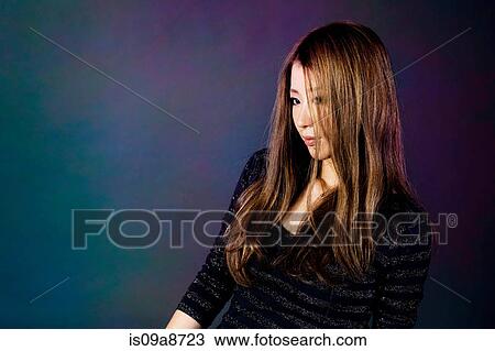 Stock Image - Studio portrait of young woman. Fotosearch