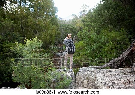 Teenage hiker taking photographs from rocks View Large Photo Image Stock Image - Teenage hiker taking photographs from rocks. Fotosearch