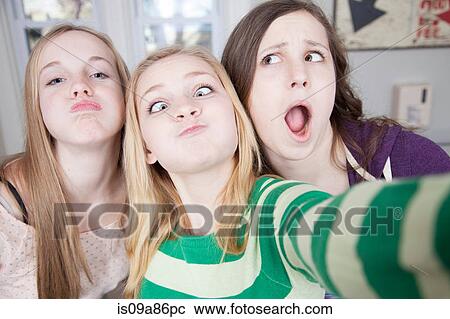 Teenagers pulling funny faces View Large Photo Image Stock Image - Teenagers pulling funny faces. Fotosearch