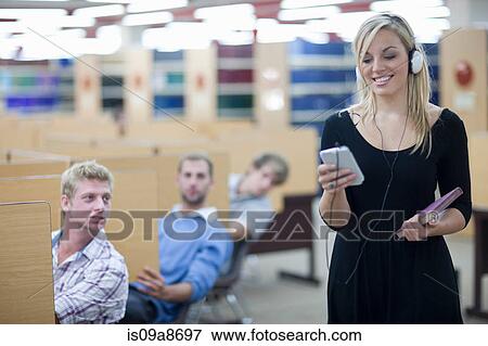 Stock Photo - Three male students watching female student. Fotosearch