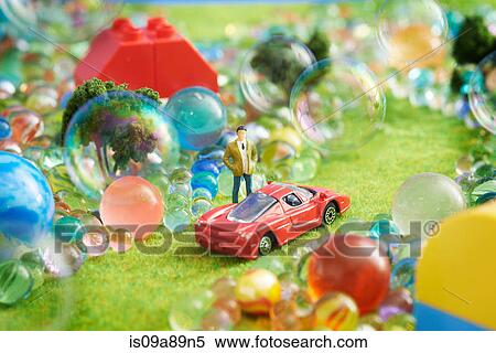 Stock Photography - Toy car and figurine with bubbles. Fotosearch