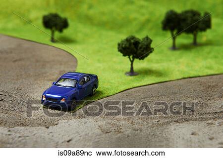 Stock Image - Toy car on model landscape. Fotosearch