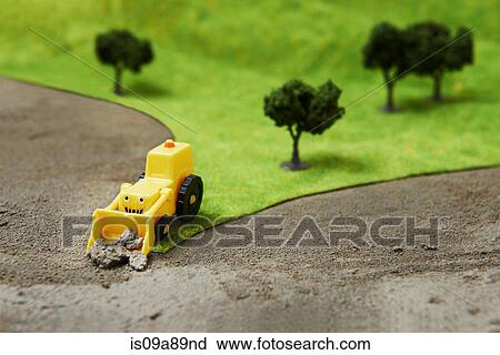 Toy digger on model landscape View Large Photo Image Stock Image - Toy digger on model landscape. Fotosearch