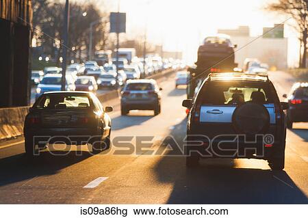 Stock Image - Traffic on sunlit highway. Fotosearch