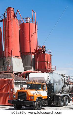 Stock Image - Truck parked by cement factory. Fotosearch