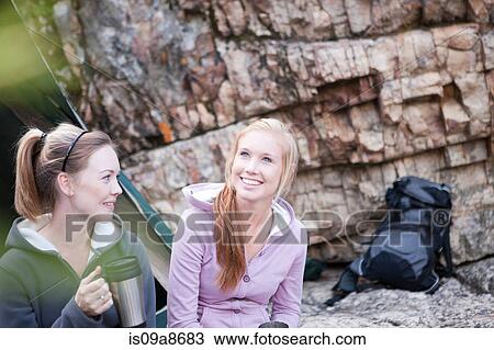 Two girls sitting outside tent View Large Photo Image Stock Image - Two girls sitting outside tent. Fotosearch