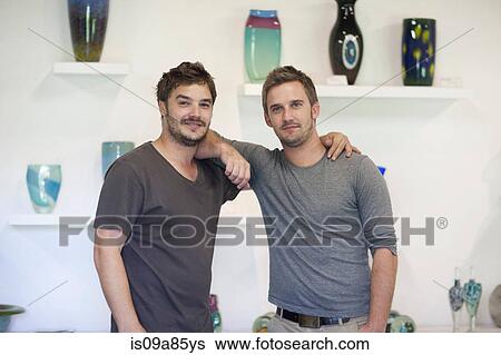 Two men in glass shop with arms around each other View Large Photo Image Stock Photograph - Two men in glass shop with arms around each other. Fotosearch