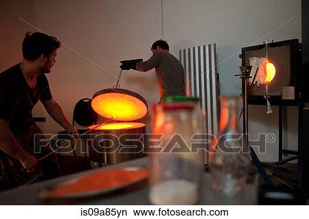 Picture - Two men working in glass factory. Fotosearch