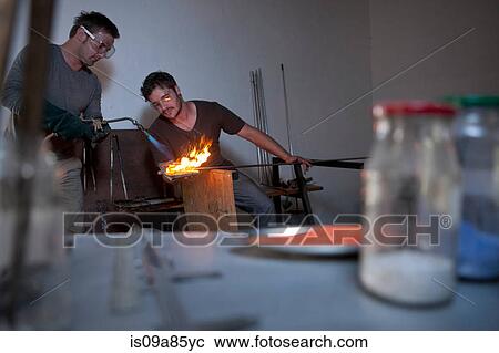 Two men working in glass factory View Large Photo Image Stock Image - Two men working in glass factory. Fotosearch