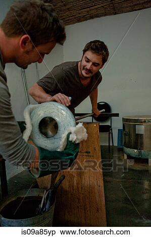 Stock Photography - Two men working in glass factory. Fotosearch