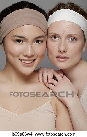 Picture - Two young women wearing headbands. Fotosearch