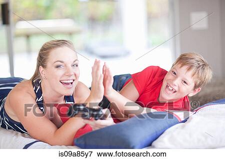 Woman and boy playing computer games View Large Photo Image Stock Photo - Woman and boy playing computer games. Fotosearch