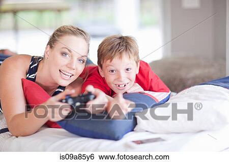 Stock Photograph - Woman and boy playing computer games. Fotosearch