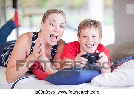 Stock Photography - Woman and boy playing computer games. Fotosearch