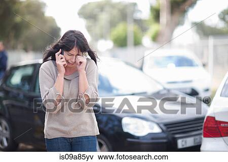 Stock Photo - Woman crying after car accident. Fotosearch