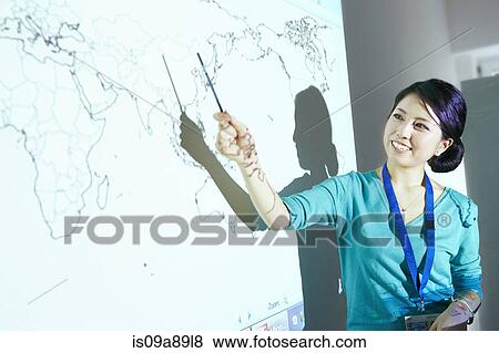 Woman doing presentation with world map projected on wall View Large Photo Image Stock Photo - Woman doing presentation with world map projected on wall. Fotosearch