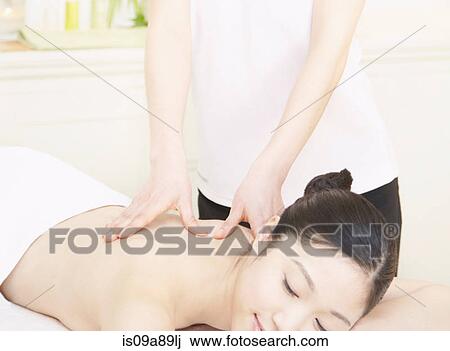 Stock Image - Woman having back massage. Fotosearch