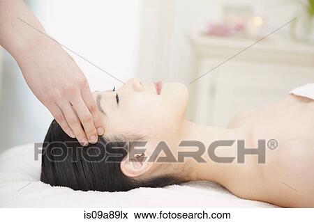 Woman having head massaged View Large Photo Image Stock Photo - Woman having head massaged. Fotosearch