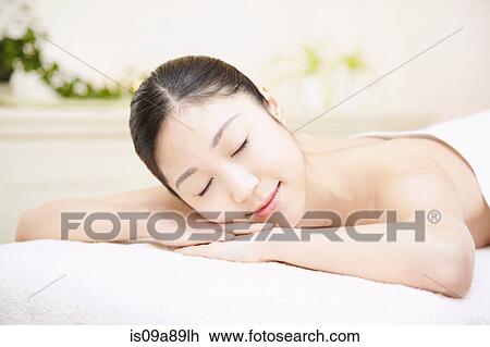 Woman lying on front in spa, eyes closed View Large Photo Image Stock Image - Woman lying on front in spa, eyes closed. Fotosearch