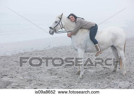 Woman riding horse on beach View Large Photo Image Stock Image - Woman riding horse on beach. Fotosearch