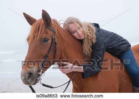 Woman riding horse on beach View Large Photo Image Stock Image - Woman riding horse on beach. Fotosearch