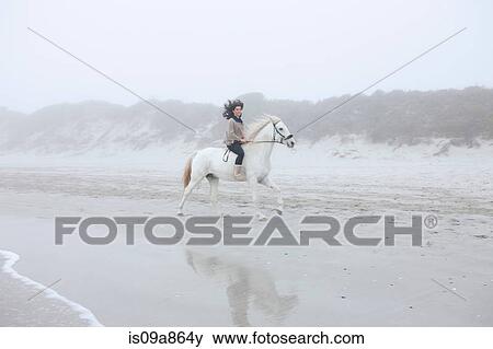 Woman riding horse on beach View Large Photo Image Stock Photo - Woman riding horse on beach. Fotosearch